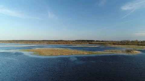 Two men stand in the middle of a spilled river in the spring floods. Stock-Footage 183540295
