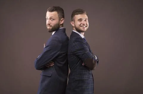 Two men standing back to back Stock Photos