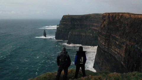 Two Men Standing on the Cliffs of Moher, Ireland Stock Footage 123442238
