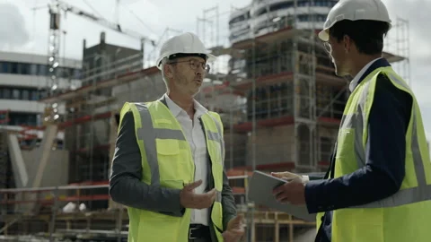 Two men standing on construction site and shaking hands Video stock 167270430