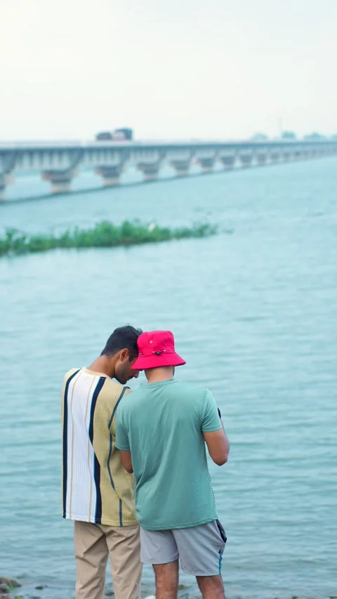 Two Men Standing by River Bridge | Stock Video | Pond5