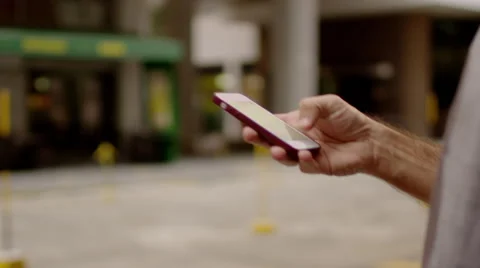Two men standing on the street and typing a text message Video stock 61273244
