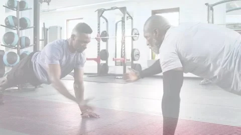 Two men starting high plank performing exchanging hand taps and pushups on Stock Footage 334242258