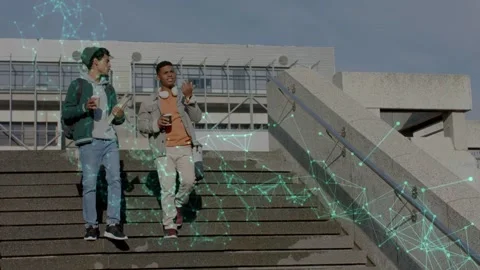 Two men stepping down stairs holding coffee, heading to class while green mesh Stock Footage 335762234