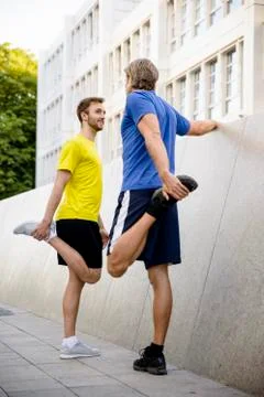 Two men stretching hamstrings Stock Photos