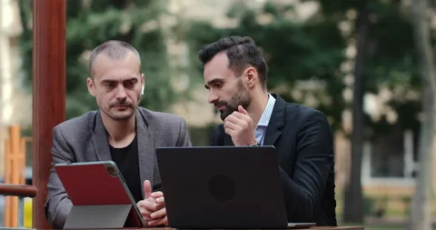 Two men in suits are discussing business Stockbeeldmateriaal 153707014