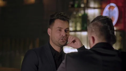 Two men in suits drink whiskey in a bar Stock Footage 105117417