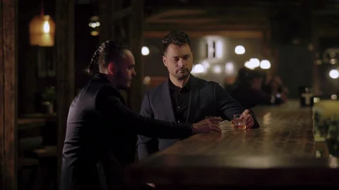 Two men in suits drink whiskey in a bar Stock Footage 105117562