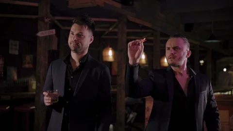 Two men in suits drink whiskey in a bar Stock Footage 105248987