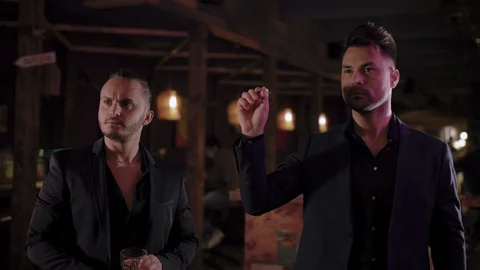Two men in suits drink whiskey in a bar Video stock 105249815