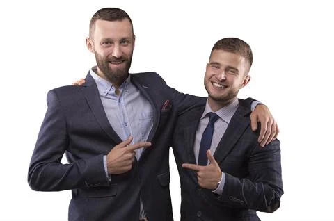 Two men in suits hugging Foto stock