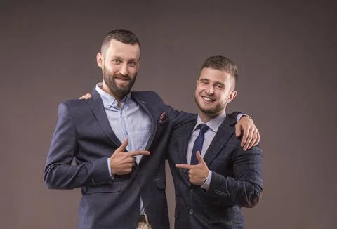 Two men in suits hugging Stock Photos