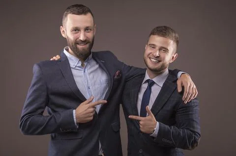 Two men in suits hugging Stock Photos