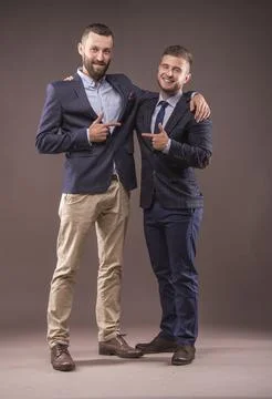Two men in suits hugging Stock Photos