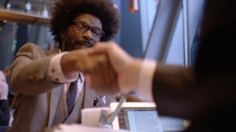 Two men in suits shake hands after a successful meeting Stock Footage 87750132