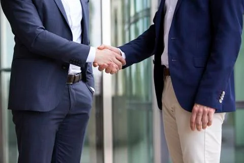 Two men in suits shaking hands Stock Photos