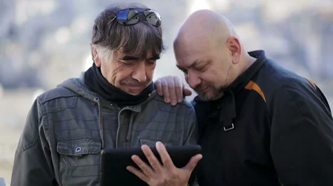 Two men surfing the internet with a tablet computer Stock Footage 34278552