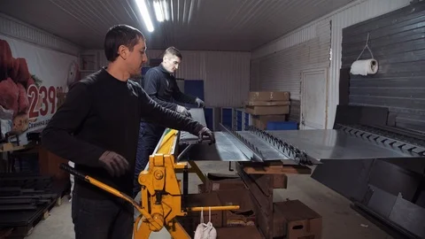 Two men synchronously working for a manual machine Stock Footage 108648726