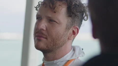 Two men talk to each other being on the moving boat Stock Footage 346638941