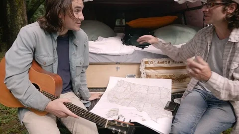 Two men talking about where to go on their road trip Stock Footage 80555394