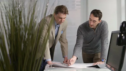 Two men talking and looking at drawings Stock-Footage 107736240