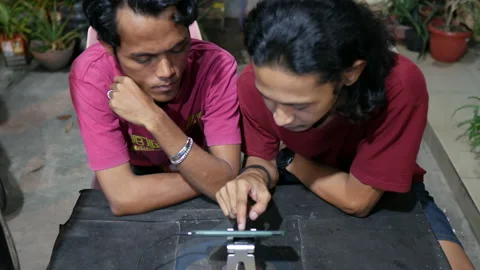 Two Men Talking And Looking At Smartphone, Close Up Stock Footage 168844263