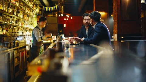 Two men talking bar relaxing together after work. Colleagues clinking glasses Stock Footage 319788801