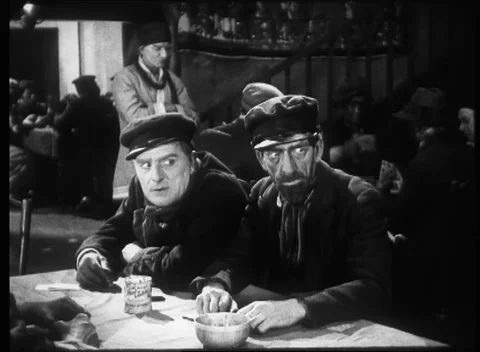 Two men talking to bunch of people across table in pub, United Kingdom, 1923 Stock Footage 172219782