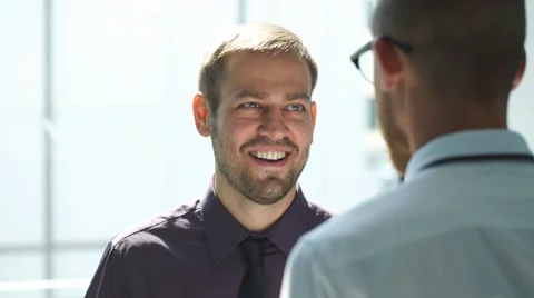 Two men talking in the lobby of the office Stock Footage 67677064