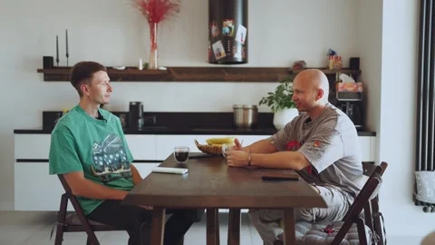 Two men talking at a table, men talking at a table, men talking Stock Footage 324214398