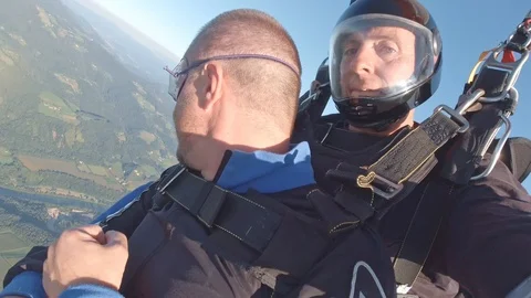 Two men tandem skydiving from airplane for sport and recreation over the Stock Footage 120155922