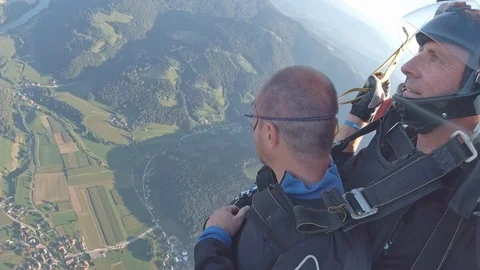 Two men tandem skydiving from airplane for sport and recreation over the Stock Footage 120155930