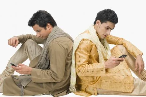 Two men text messaging on mobile phones Stock Photos