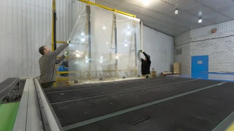 Two men thrown from the rack, the glass sheet on the cutting table. Stock-Footage 124121708