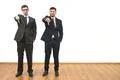 The two men thumb down on the white wall background Photo