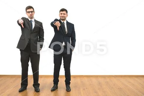 The two men thumb down on the white wall background Stock Photos