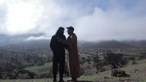 Two Men Traditional and Modern Overlooking Scenic Morocco Mountain Valley 스톡 동영상 332773022