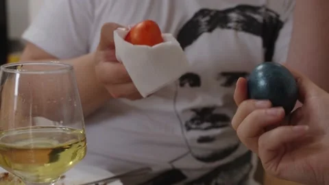 Two men traditionally beat eggs at Easter. Easter holiday and tradition Stock Footage 204131341