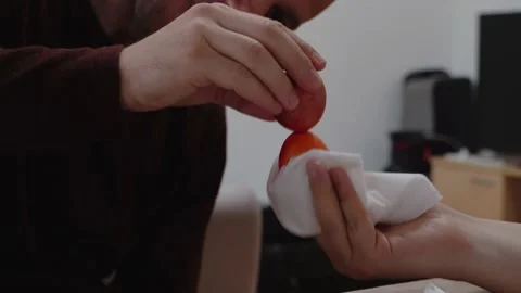 Two men traditionally beat eggs at Easter. Easter holiday and tradition Stock Footage 214501663