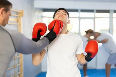 Two men training boxing fight in studio Stock Photos