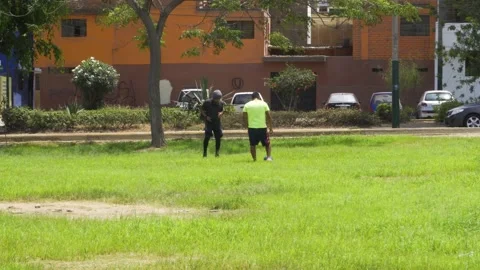 Two men training soccer in a park in the daytime 库存影片 149898658