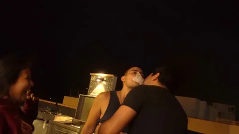 Two men try to pass a piece of paper with their lips in a game between friends Video stock 193030127