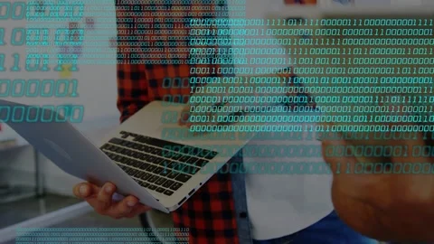 Two men typing in IT office, tapping laptop and tablet, activating binary Stock Footage 335739218
