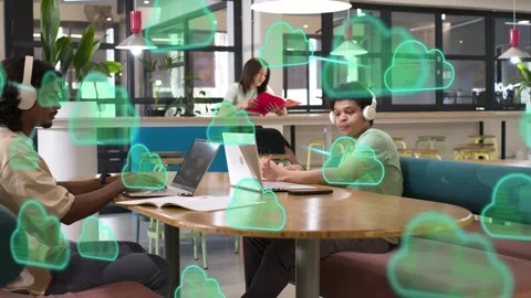 Two men typing in tech workspace, laptops causing green clouds flooding then Stock Footage 334694097