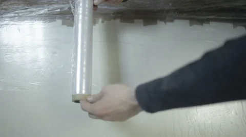 Two men unwrap the packing tape Video stock 68067430