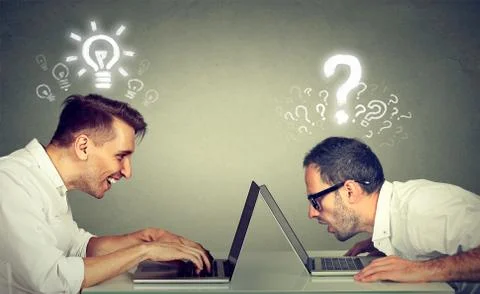 Two men using laptop computer one educated has bright ideas the other ignor.. Foto stock