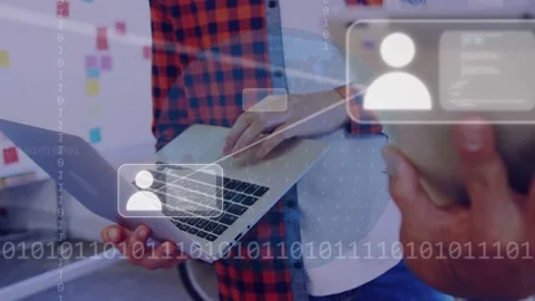 Two men using laptop pad and swiping tablet initiating tech overlays with user Stock Footage 334810883
