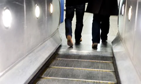 Two men using the London underground escalators with intentional blurred moti Stock Photos