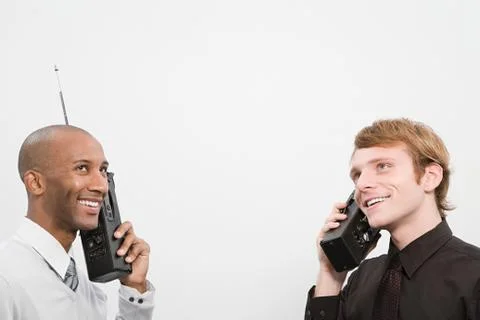 Two men using walkie talkies Stock Photos