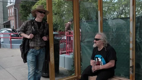 Two men waiting at the bus stop in Pittsburgh Stock Footage 213579546